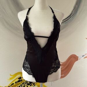 Forever 21 lingerie body suit.  Size small. Silky black lace.  Snaps at bottom.